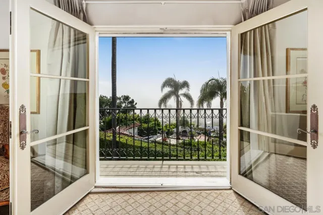 a view of a balcony with a palm tree