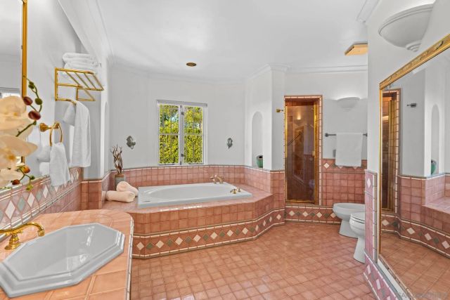 a spacious bathroom with a tub and shower