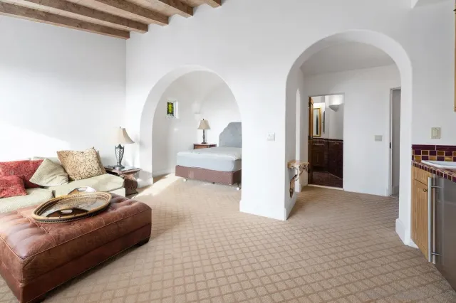 a bathroom with a granite countertop toilet sink and mirror