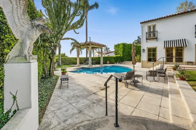 a view of an outdoor dining space with a table and chairs
