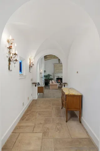 a view of hall way with furniture and a dining table