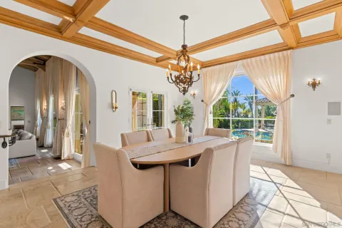 a view of a dining room with furniture wooden floor and chandelier
