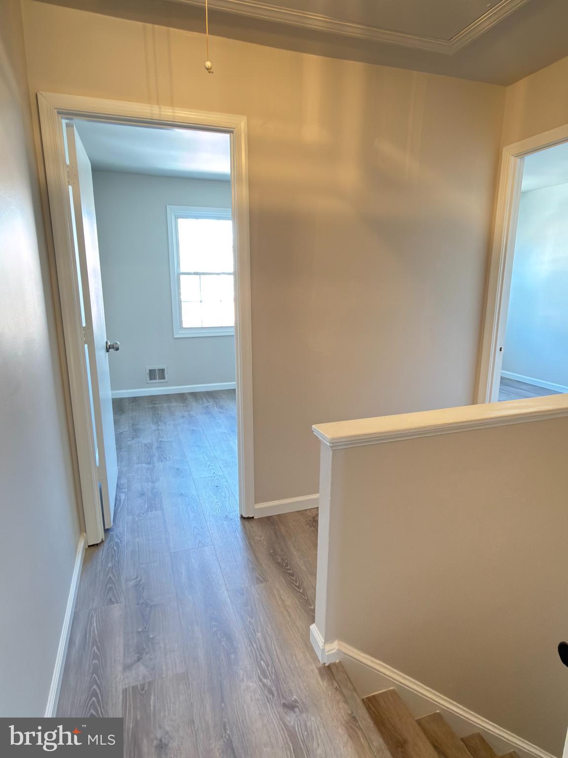 9203 Hood Road Manassas, VA 20110 - Photo 11 of 23 a view of an empty room with wooden floor and a window