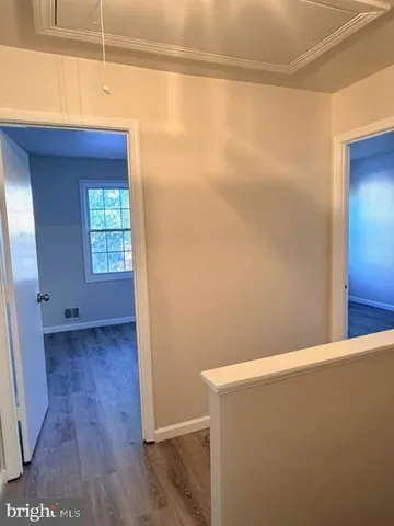 a view of a room with wooden floor and cabinet