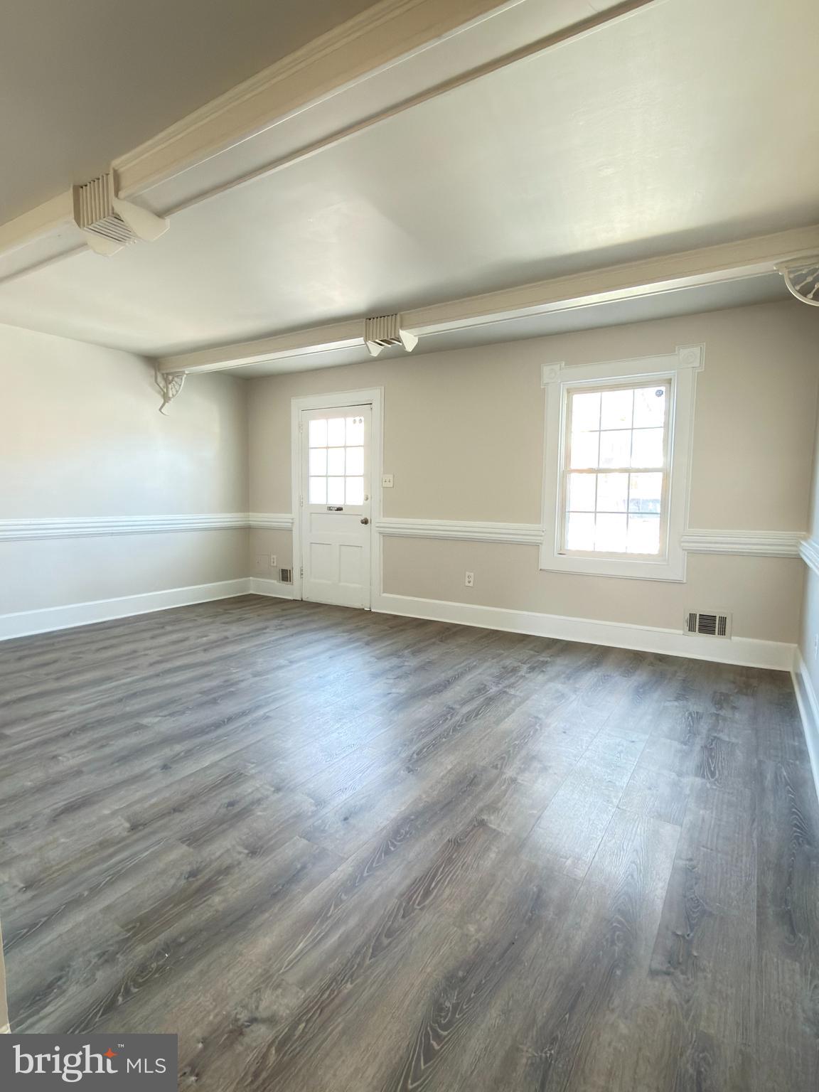 9203 Hood Road Manassas, VA 20110 - Photo 2 of 23 an empty room with wooden floor and windows