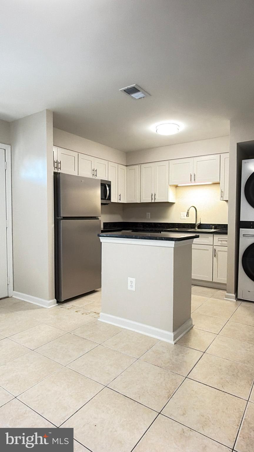 9203 Hood Road Manassas, VA 20110 - Photo 6 of 23 a kitchen with granite countertop a refrigerator and a sink