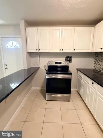 a kitchen with cabinets and appliances