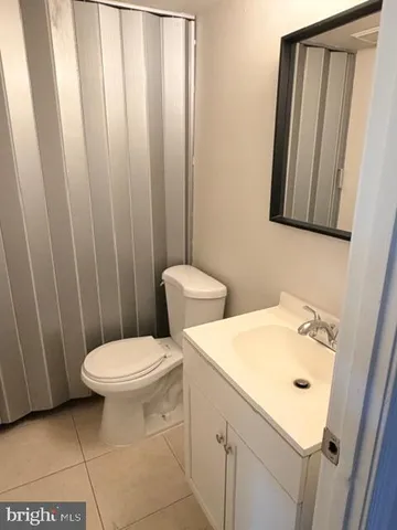 a white toilet sitting next to a white sink