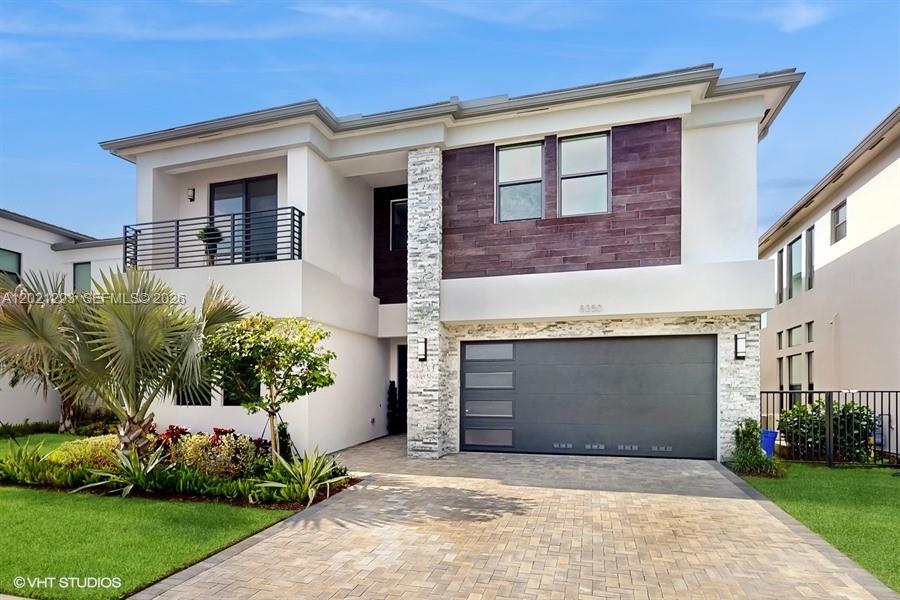 8350 Royal County Down Road Boca Raton, FL 33434 - Photo 2 of 52 a front view of a house with a garden