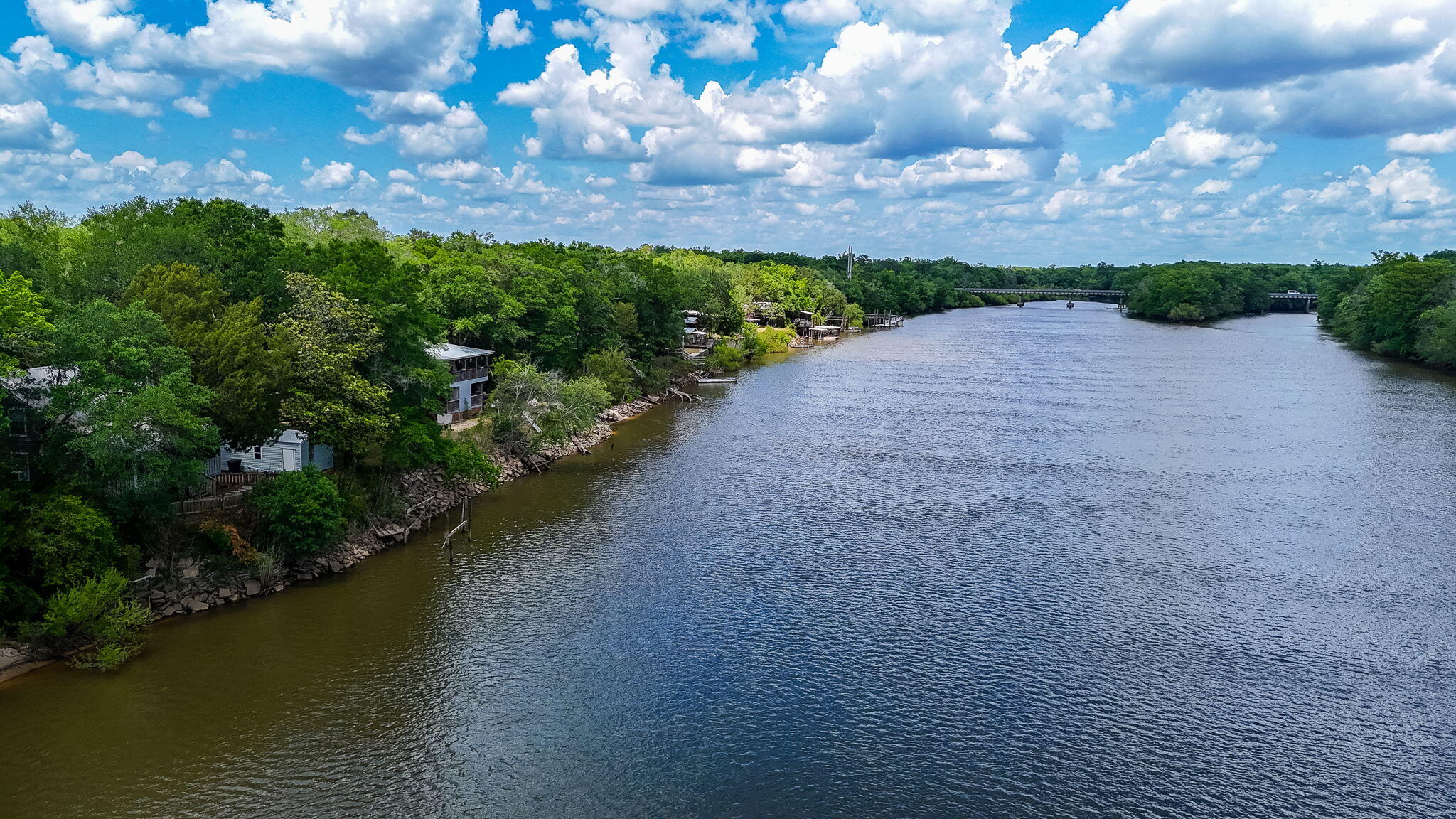 439 Big Cedar Road Ponce de Leon, FL 32455 - Photo 17 of 48 a view of a lake with a building in the background