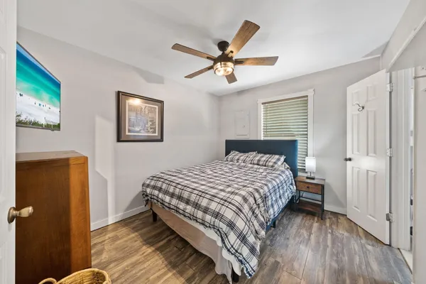 a bedroom with a bed and a chandelier