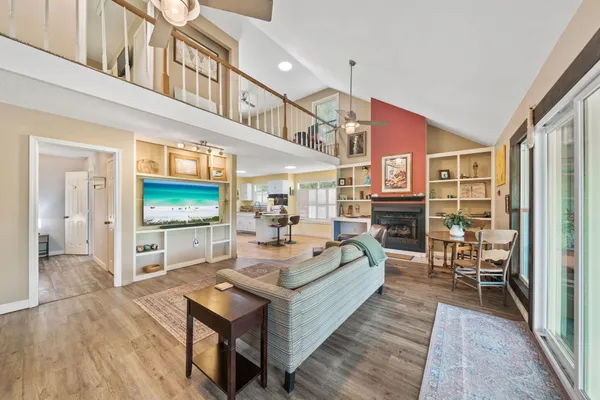 a living room with fireplace furniture and a flat screen tv