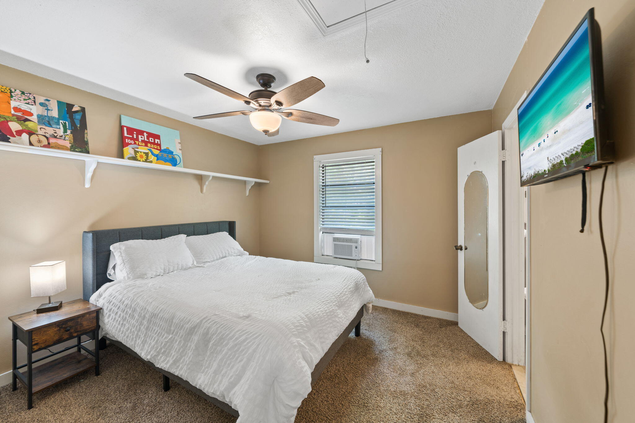 439 Big Cedar Road Ponce de Leon, FL 32455 - Photo 27 of 48 a bedroom with a bed a ceiling fan and a book shelf