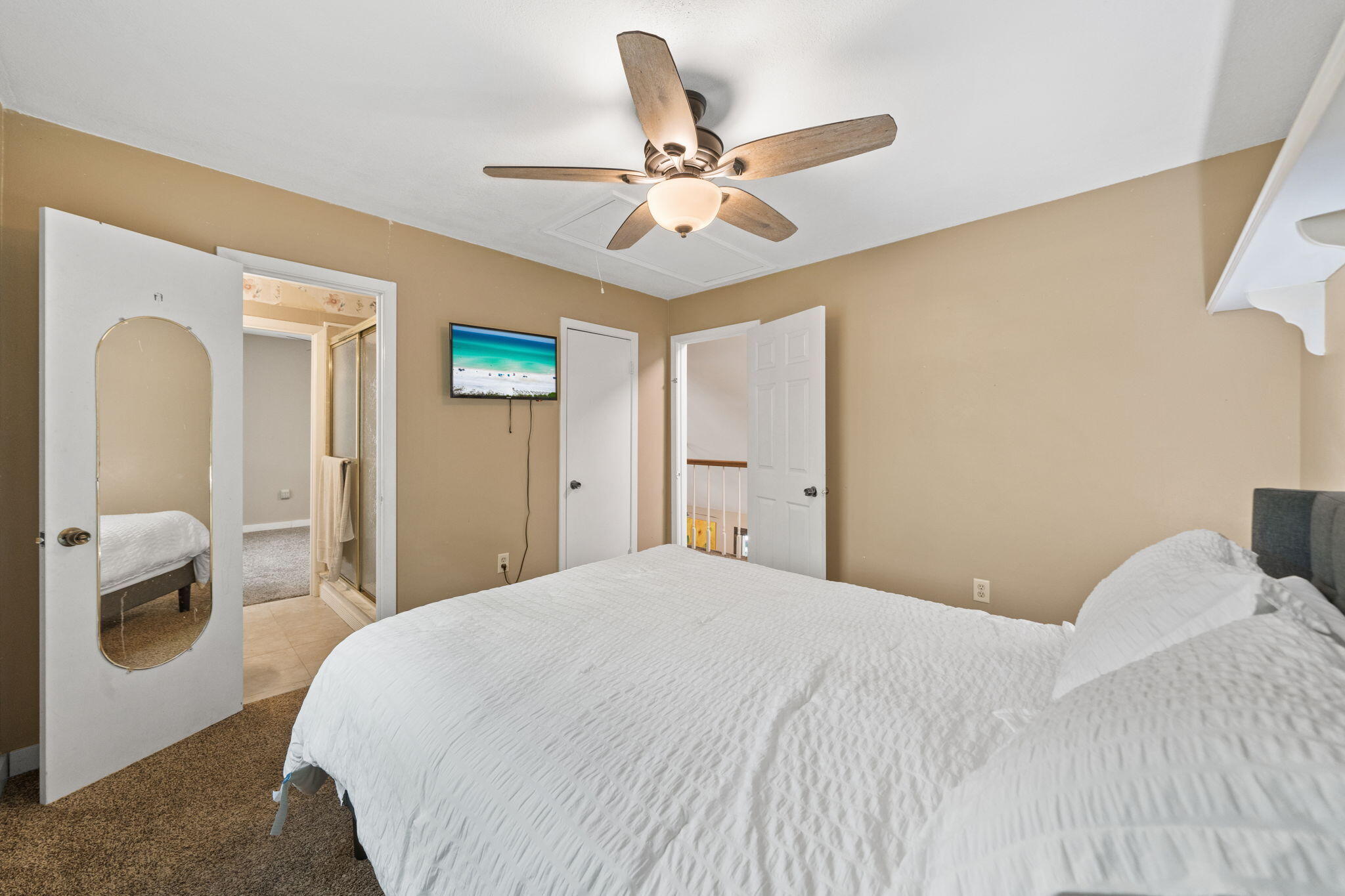 439 Big Cedar Road Ponce de Leon, FL 32455 - Photo 28 of 48 a bedroom with a large bed and a chandelier