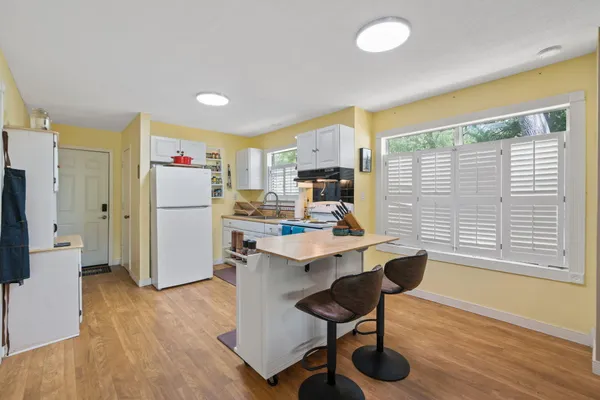 a room with furniture a flat screen tv and a refrigerator