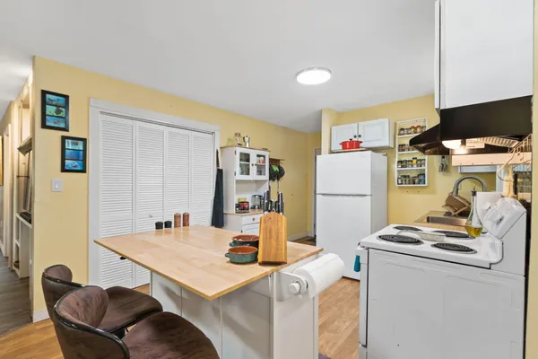 a kitchen with sink cabinets and wooden floor