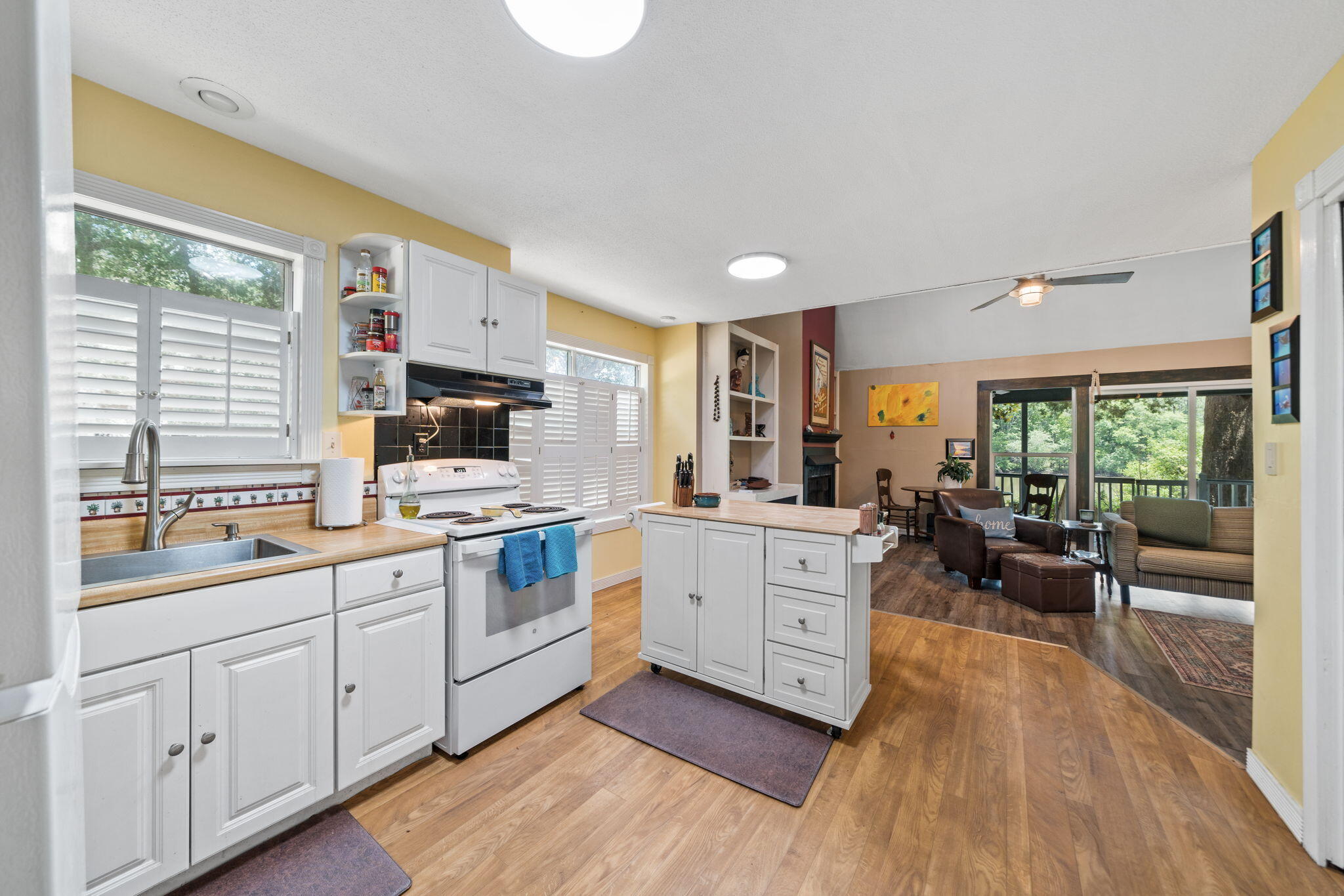 439 Big Cedar Road Ponce de Leon, FL 32455 - Photo 36 of 48 a kitchen with sink cabinets and wooden floor