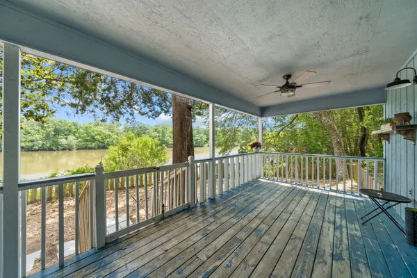 a view of a porch with furniture and a yard