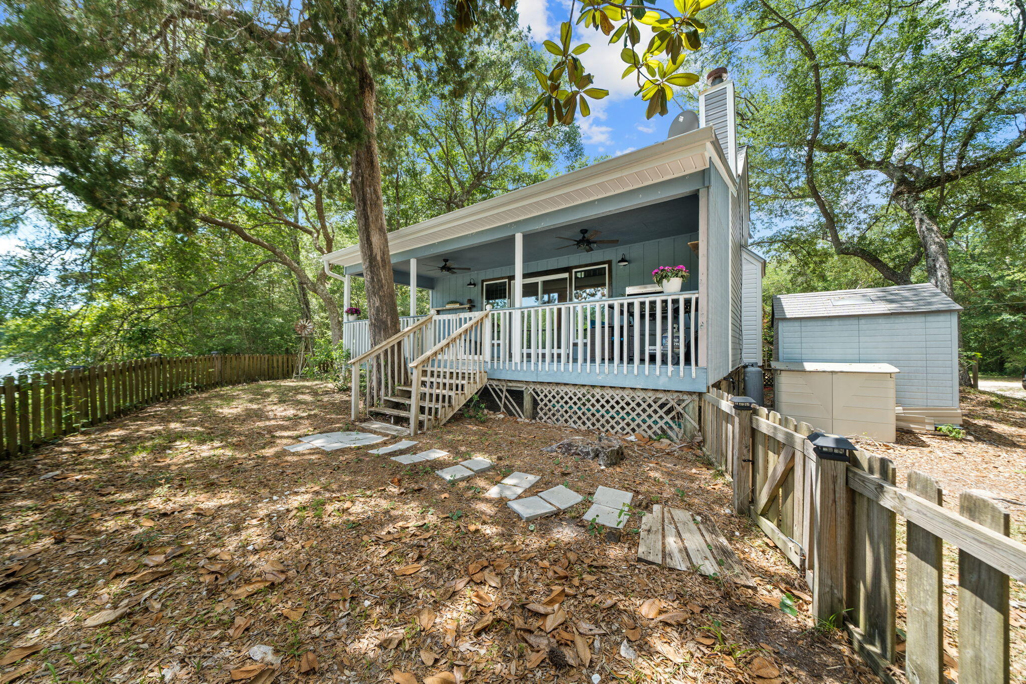 439 Big Cedar Road Ponce de Leon, FL 32455 - Photo 40 of 48 a view of a chair and table in backyard of the house