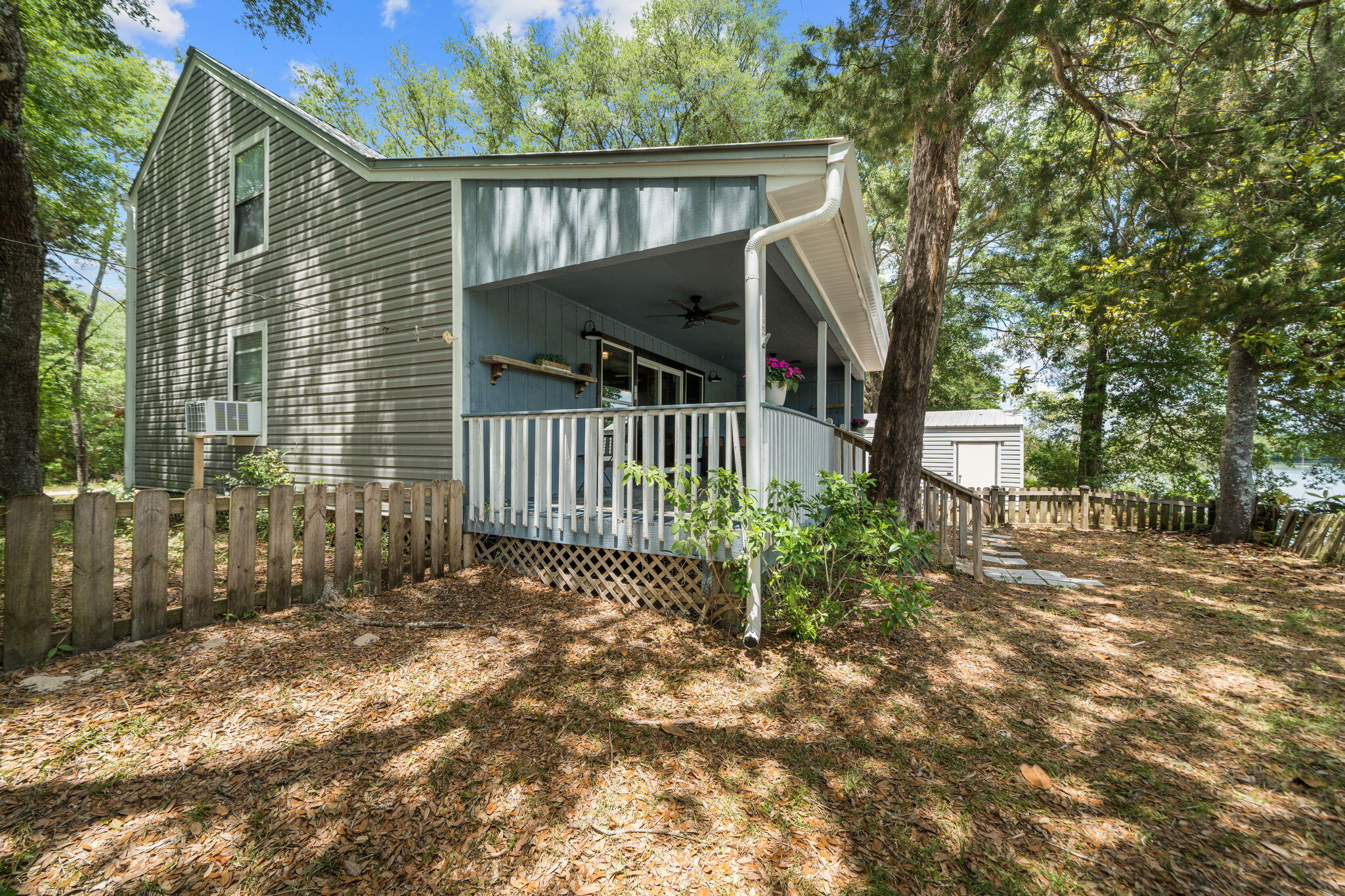 439 Big Cedar Road Ponce de Leon, FL 32455 - Photo 6 of 48 a view of a house with a small yard and wooden fence and large trees
