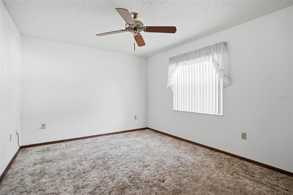 2414 Appian Avenue Spring Hill, FL 34608 - Photo 15 of 37 a view of empty room with ceiling fan