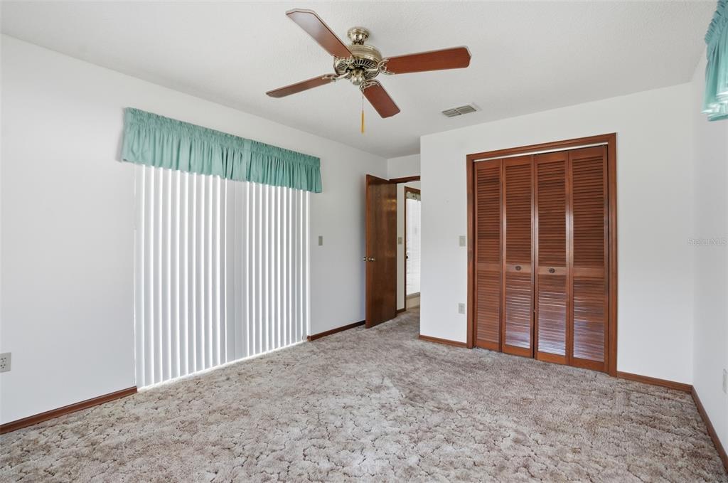2414 Appian Avenue Spring Hill, FL 34608 - Photo 18 of 37 an empty room with closet and ceiling fan