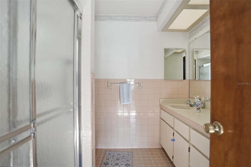 2414 Appian Avenue Spring Hill, FL 34608 - Photo 20 of 37 a bathroom with a sink a mirror and shower