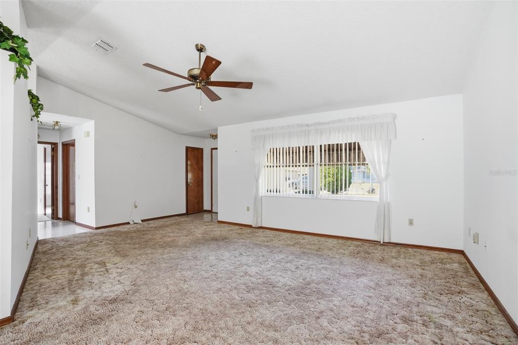 2414 Appian Avenue Spring Hill, FL 34608 - Photo 2 of 37 an empty room with windows and fan