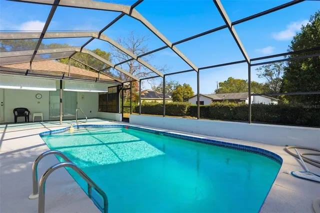 a view of a backyard with a swimming pool