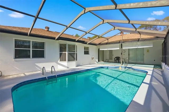 a swimming pool with outdoor seating and yard