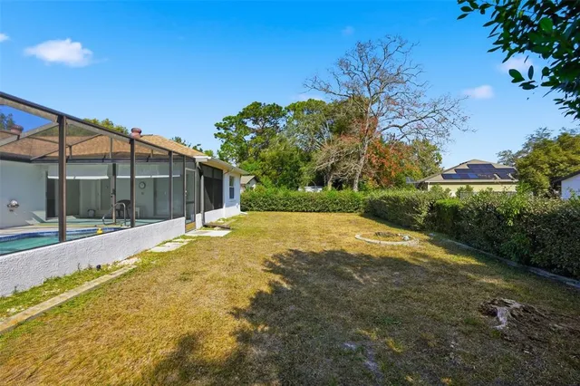 a view of a house with backyard and tree