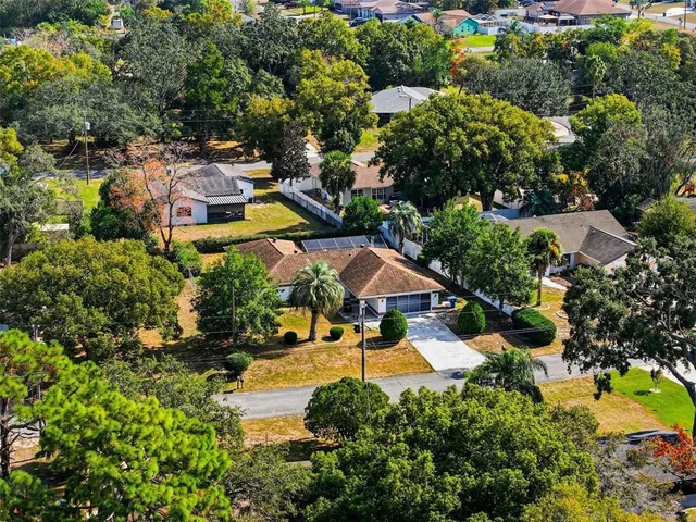 an aerial view of residential houses with yard