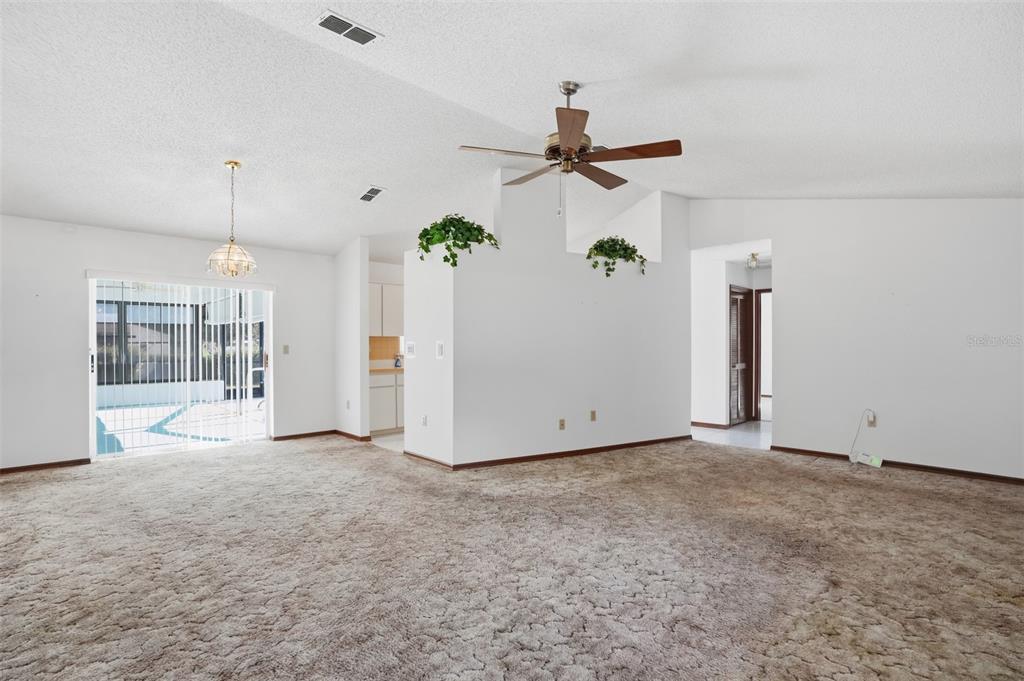 2414 Appian Avenue Spring Hill, FL 34608 - Photo 4 of 37 a view of a room with a refrigerator and ceiling fan