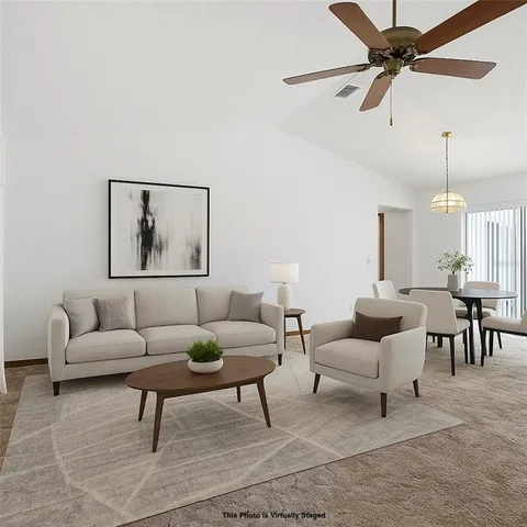 a living room with furniture a rug and a chandelier