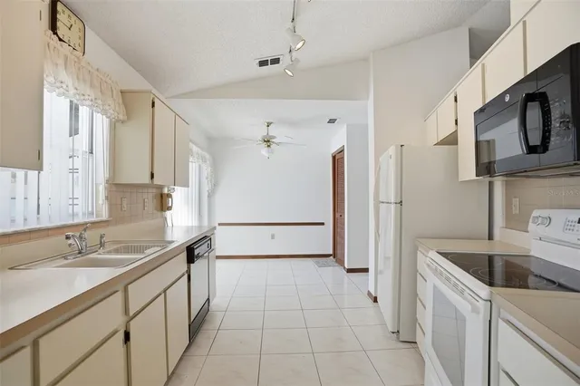 a kitchen with a sink cabinets and refrigerator