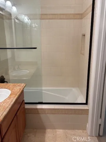 a bathroom with a shower and a bath tub