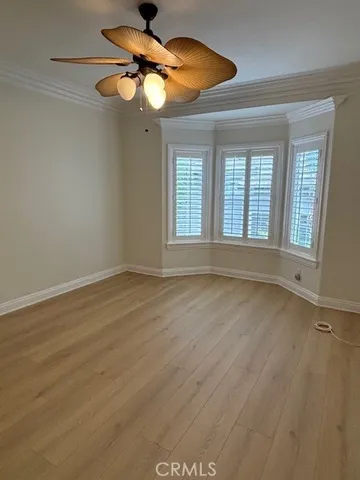 a view of a chandelier fan and wooden floor