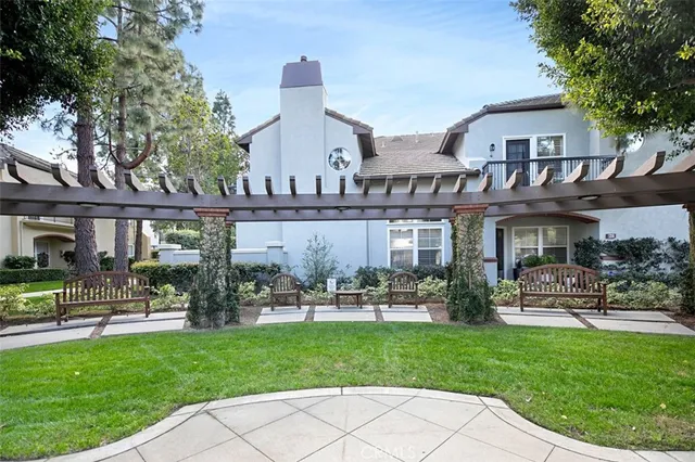 a front view of a house with a yard and fountain