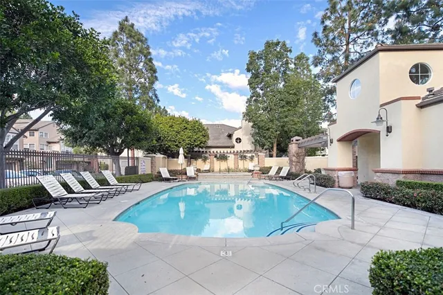 a view of a house with backyard and sitting area