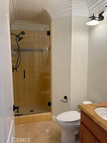 a bathroom with a granite countertop shower toilet and sink