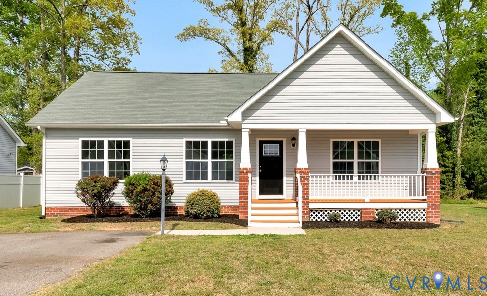 9925 Reymet Court Richmond, VA 23237 - Photo 1 of 30 a front view of a house with a yard and garage