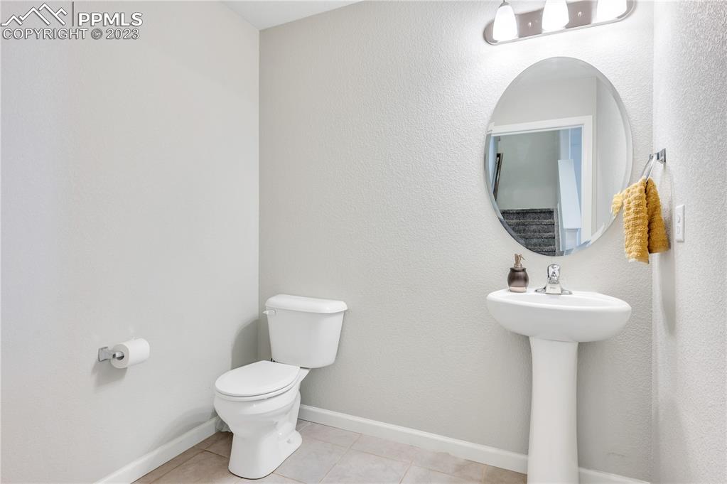2118 Birmingham Loop Colorado Springs, CO 80910 - Photo 11 of 28 a bathroom with a toilet sink and mirror