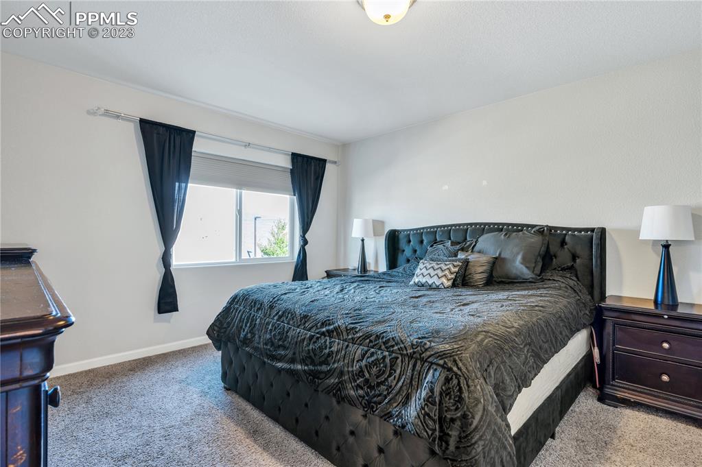 2118 Birmingham Loop Colorado Springs, CO 80910 - Photo 13 of 28 a bedroom with a bed and window