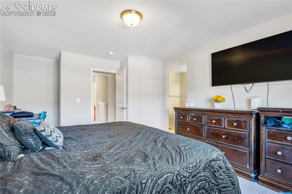 2118 Birmingham Loop Colorado Springs, CO 80910 - Photo 15 of 28 a bedroom with a bed and flat screen tv