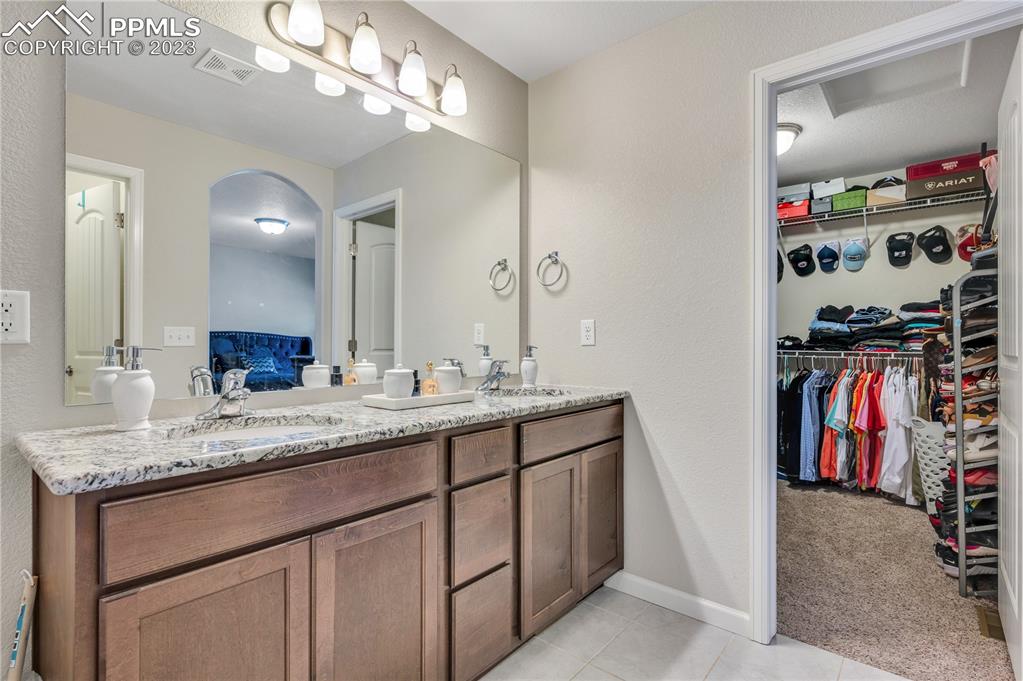 2118 Birmingham Loop Colorado Springs, CO 80910 - Photo 17 of 28 a bathroom with a sink double vanity and a mirror