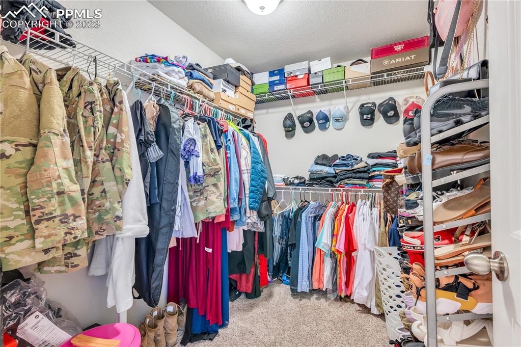2118 Birmingham Loop Colorado Springs, CO 80910 - Photo 18 of 28 a view of walk in closet with clothes