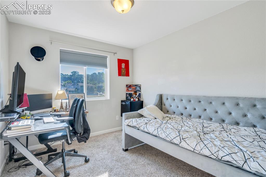 2118 Birmingham Loop Colorado Springs, CO 80910 - Photo 19 of 28 a bedroom with furniture and a window