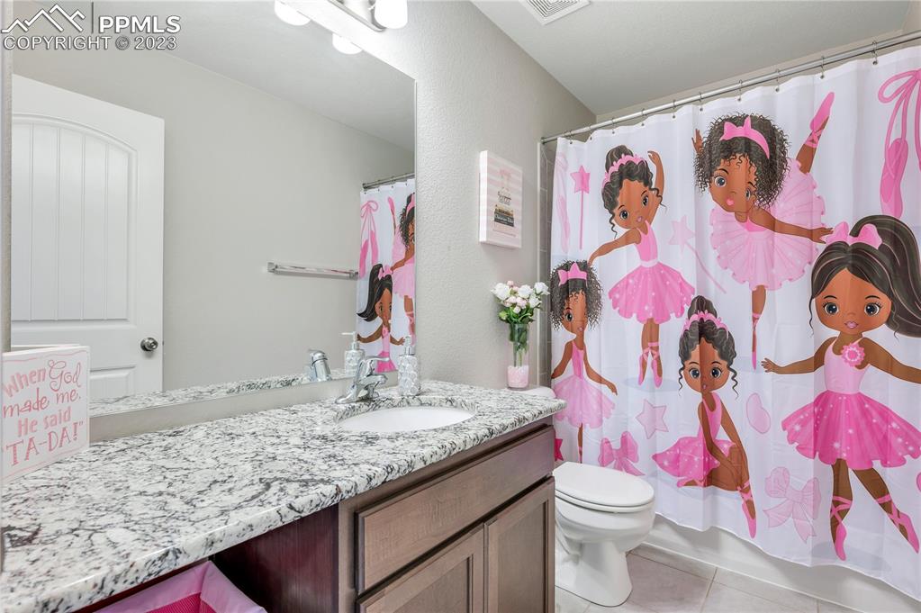 2118 Birmingham Loop Colorado Springs, CO 80910 - Photo 21 of 28 a bathroom with a sink and toilet