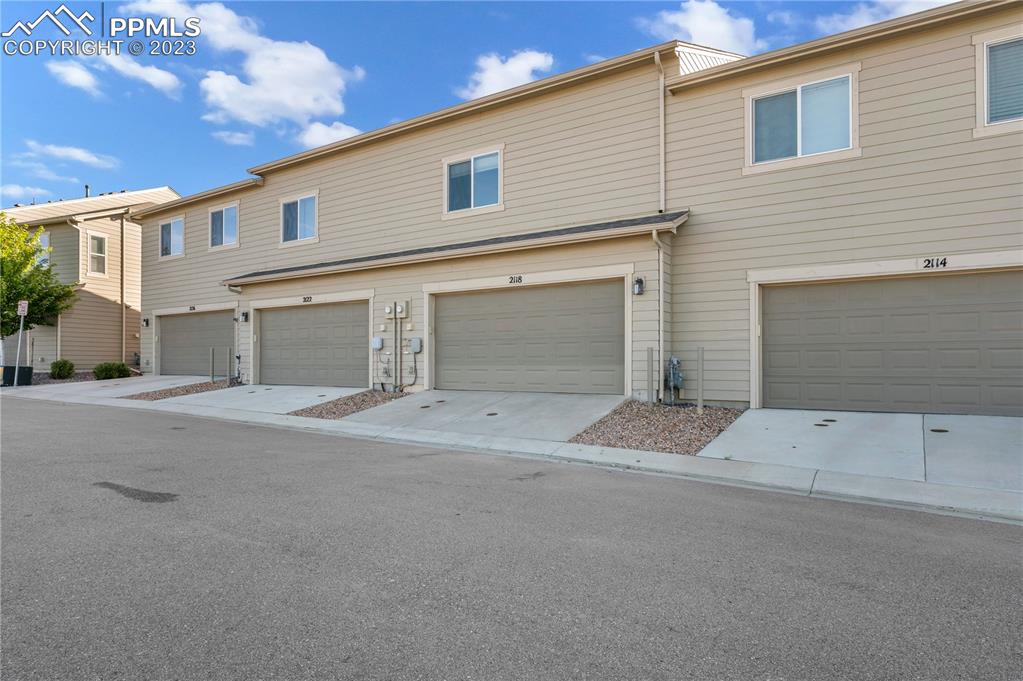2118 Birmingham Loop Colorado Springs, CO 80910 - Photo 25 of 28 front view of a house with a yard