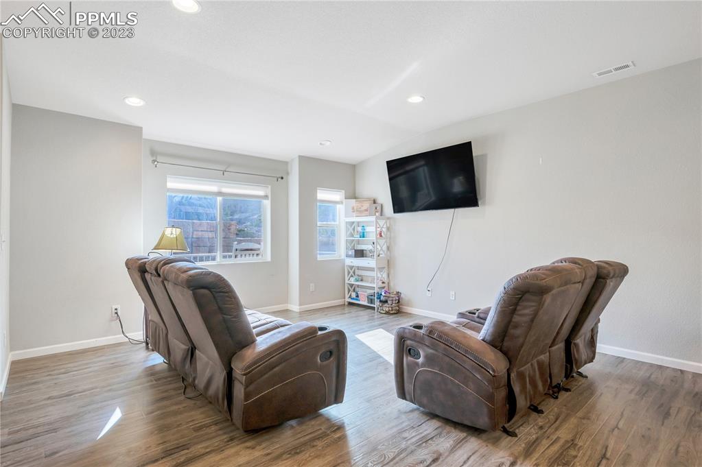 2118 Birmingham Loop Colorado Springs, CO 80910 - Photo 4 of 28 a living room with furniture and a flat screen tv